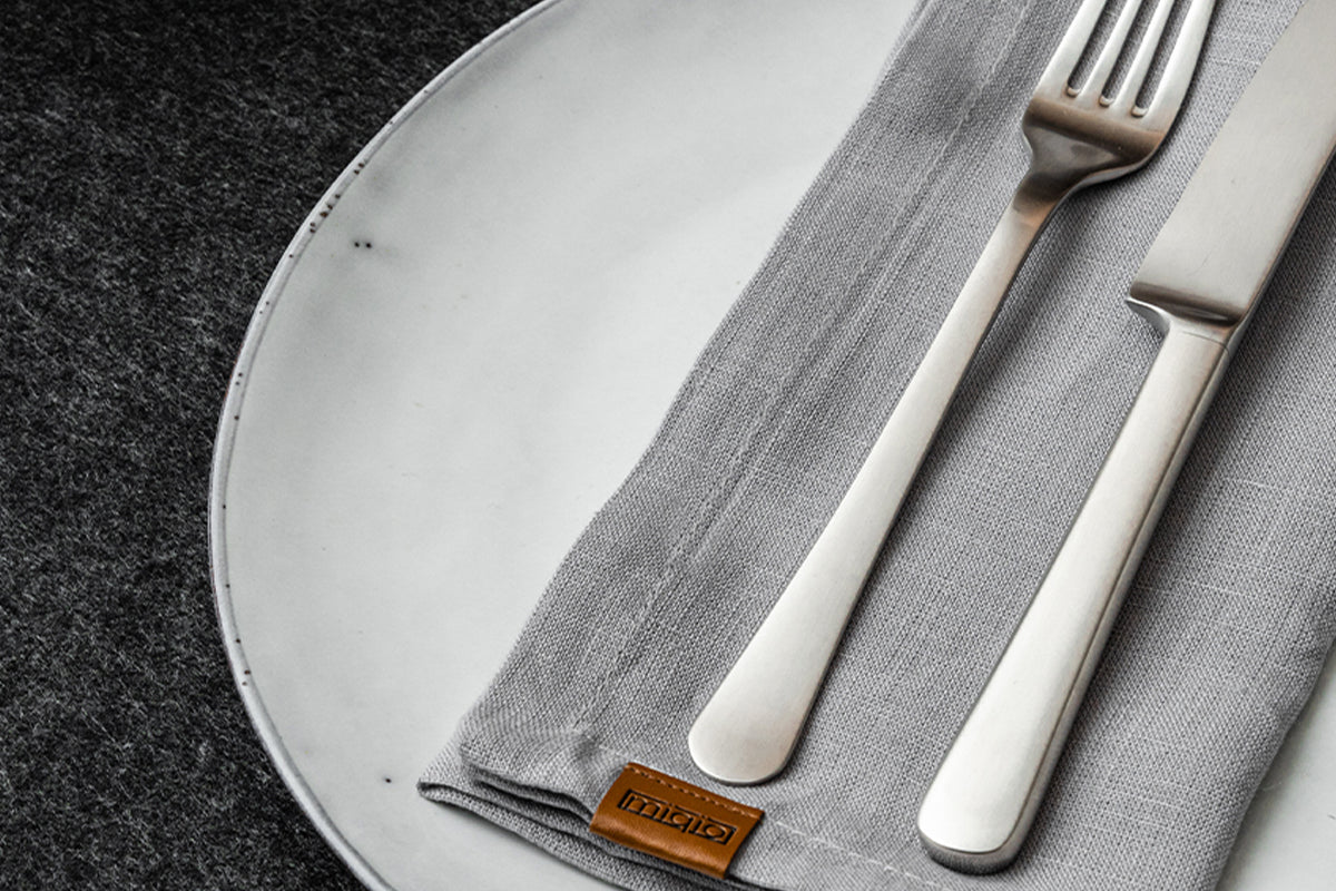 MIQIO® Design Leinenserviette aus 100% Leinen in Hellgrau mit Markenlabel aus echtem Leder